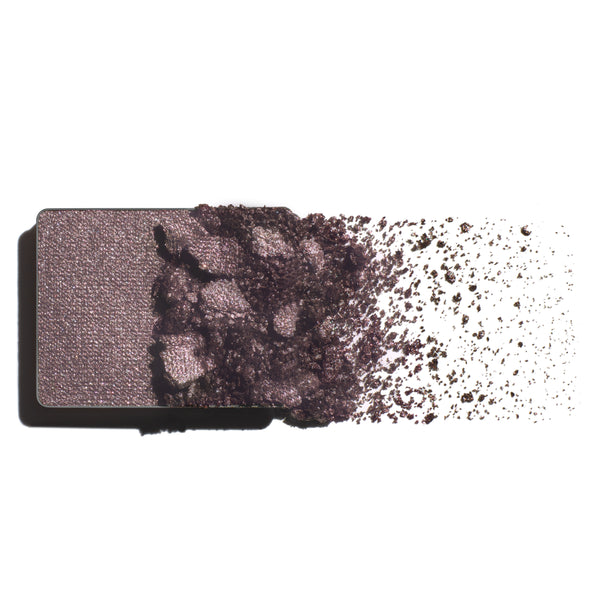 Makeup eyeshadow refill with taupe-amethyst powder on a white background