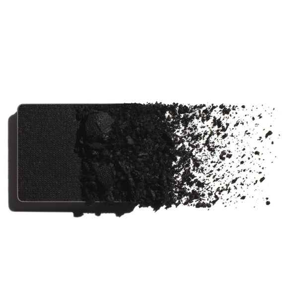 Makeup eyeshadow refill with true black powder on a white background