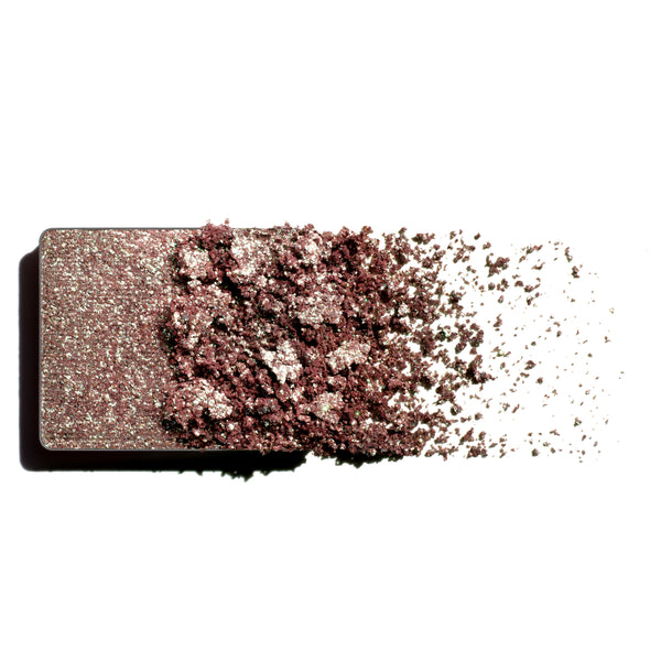 Makeup eyeshadow refill with green to heather monochromatic powder on a white background