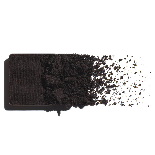 Makeup eyeshadow refill with dark violet powder on a white background