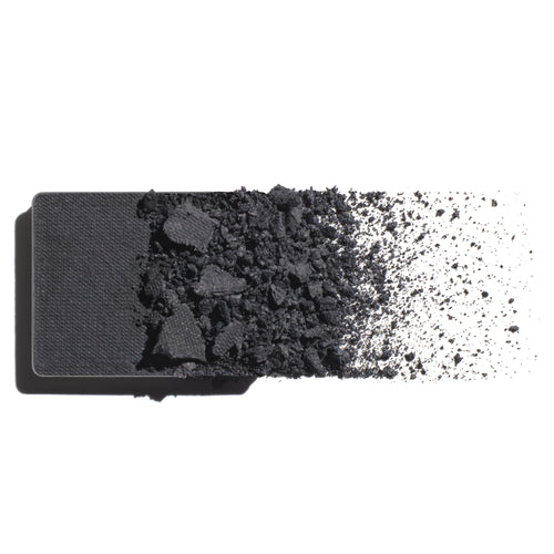 Makeup eyeshadow refill with cool, grey slate powder on a white background
