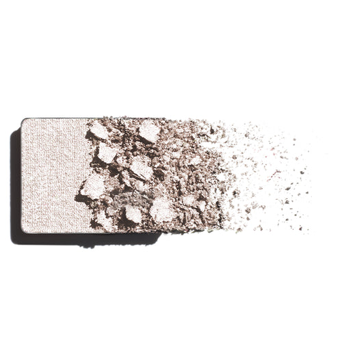 Makeup eyeshadow refill with champagne powder on a white background